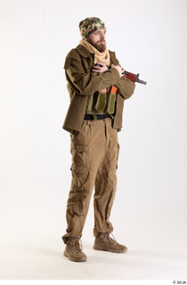 Andrew Elliott Insurgent Holding GGun holding gun standing whole body…
